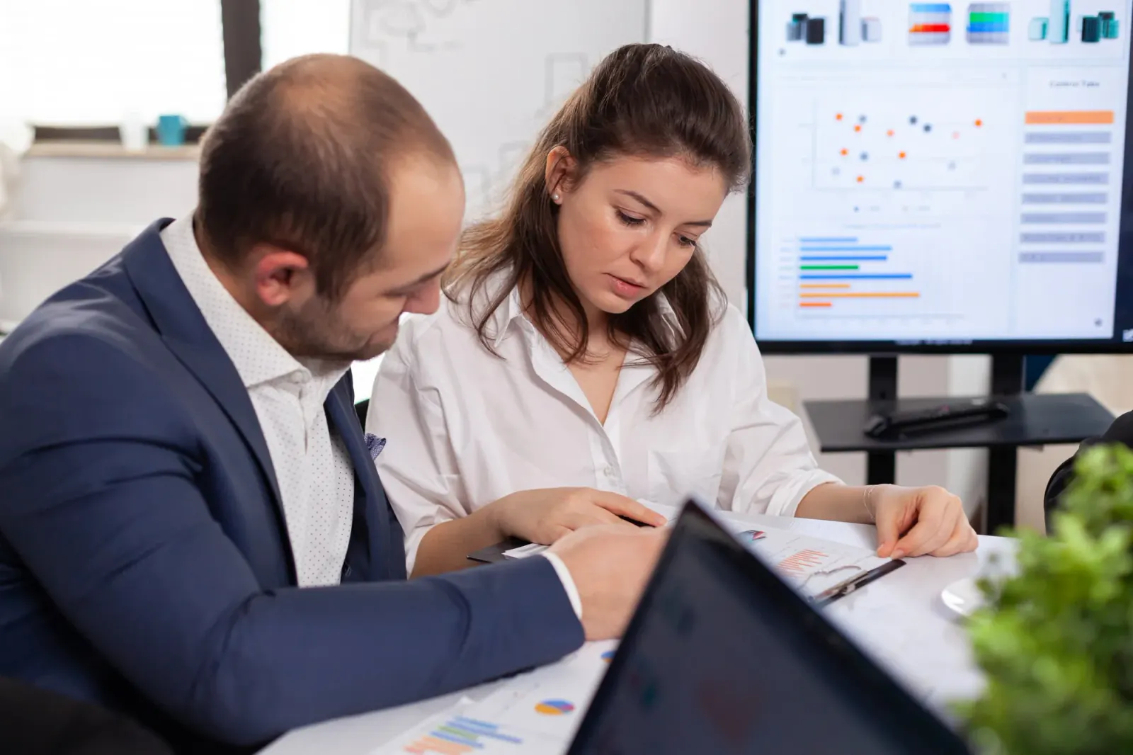 Financial professionals reviewing reports and business data